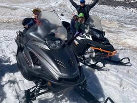 Group on a snowmobile in the mountains