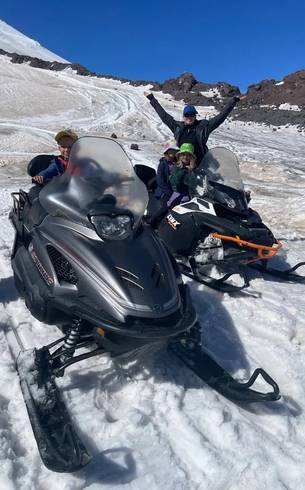 Group on a snowmobile in the mountains