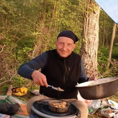 Alexander Ageev cooking at camp