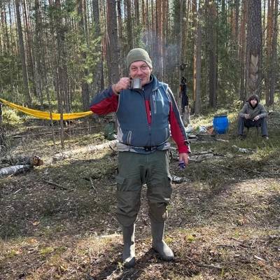 Sergey Bokanev at a camp in a pine forest
